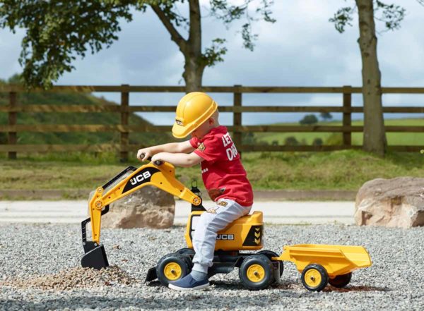 Child playing with backhoe JCB 115A outdoors