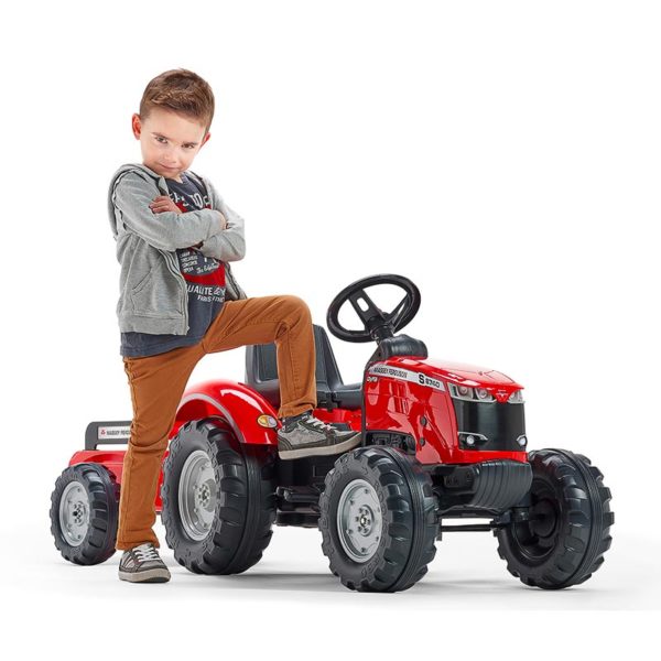 Little boy playing with Falk Toys Massey Ferguson Red Pedal Tractor 4010AB