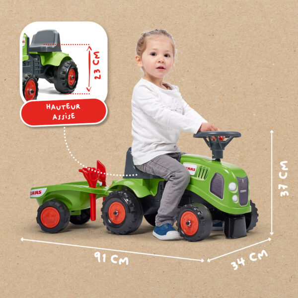 Enfant sur porteur tracteur Claas