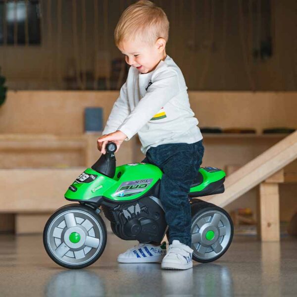 Boy on Draisienne motorbike Bud Racing