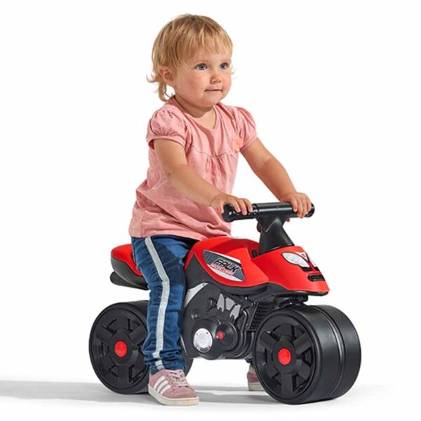 Girl playing Draisienne motorbike racing team red