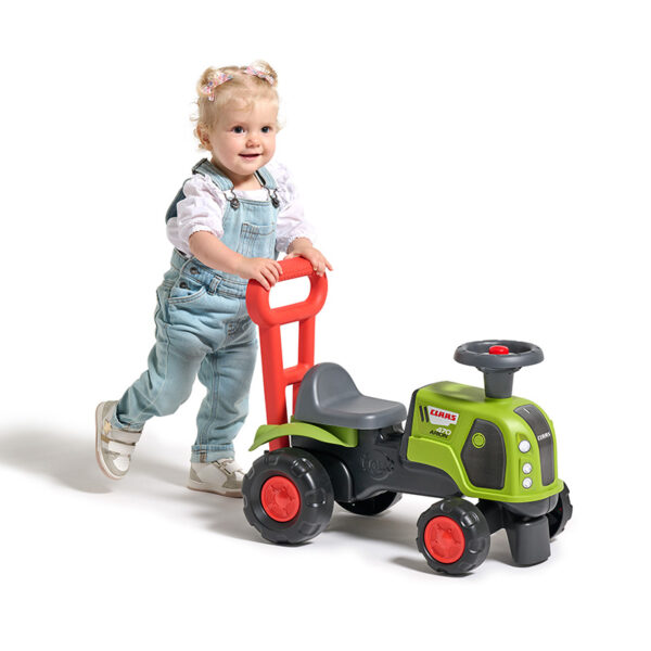 Girl on Ride-on Tractor Claas