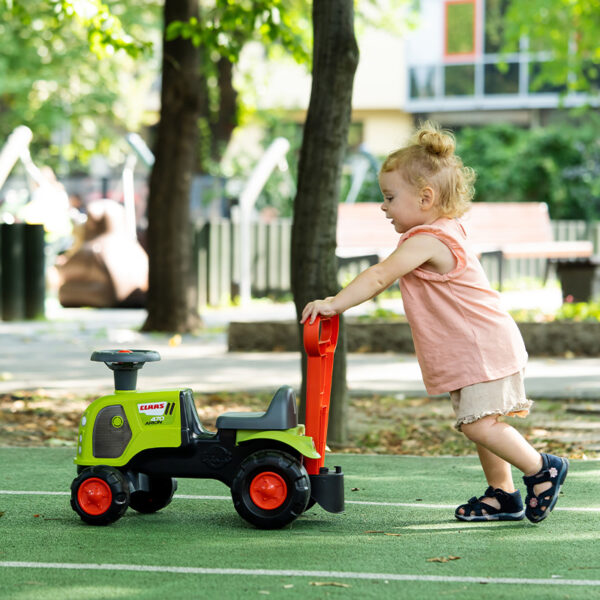 Girl with Ride-on Tractor Claas