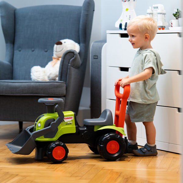 Boy with  Ride-on Tractor Claas