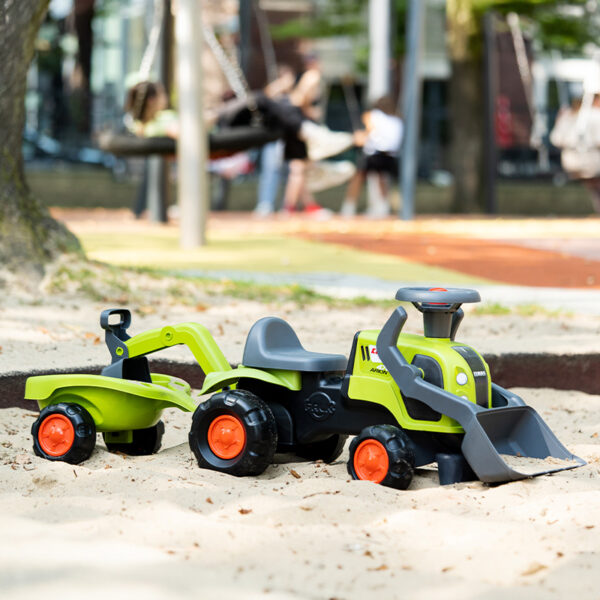 Girl and parent with Ride-on Tractor Claas