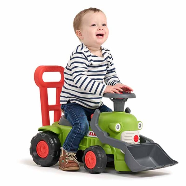 Boy on Ride-on Tractor CLAAS with front shovel