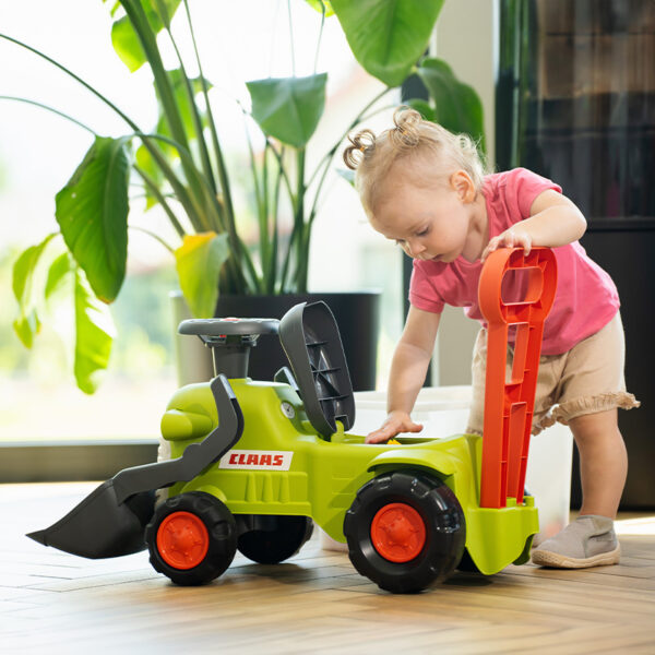 Girl with Ride-on Tractor CLAAS with front shovel