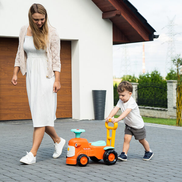 Kid and parent with Ride-on Tractor Kubota