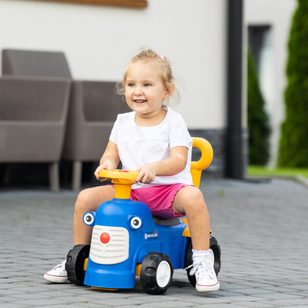 Girl on Ride-on Tractor New Holland