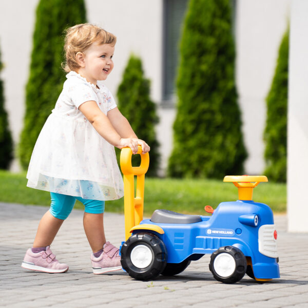 Girl with Ride-on Tractor New Holland