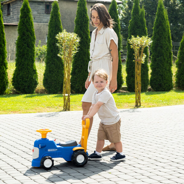 Kid and parents with Ride-on Tractor New Holland