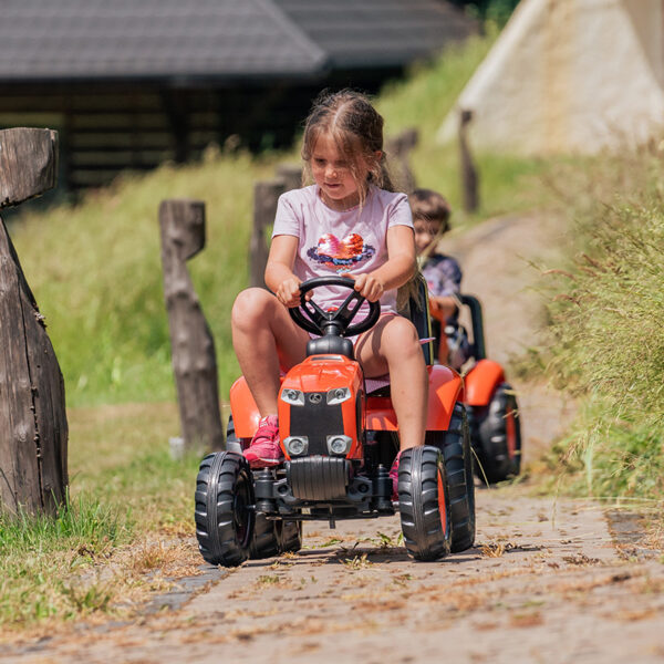 Niño jugando en tractor pedal Kubota Falk Toys 2060AB