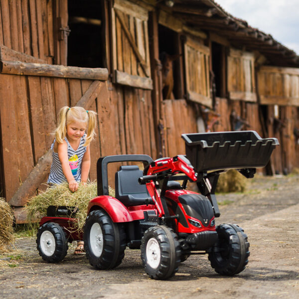 Kid playing with Backhoe loader pedal Valtra 4000AM